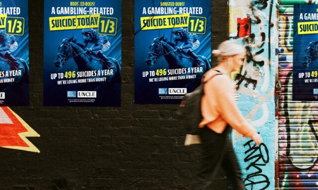 A poster on a wall shows the impact gambling has on suicide rates